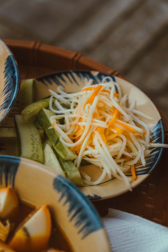 Close-up of a vibrant Vietnamese salad with cucumbers and shredded vegetables in Ho Chi Minh City.